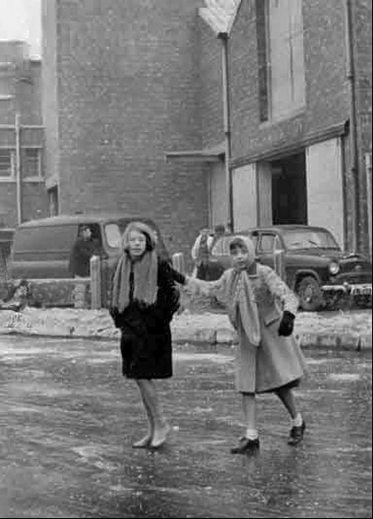 girls crossings icy canal 1960s